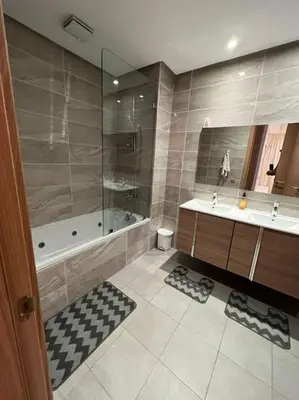 a bathroom with a tub and a sink and a shower at Lovely Appartement Prestigia Hayriad in Rabat