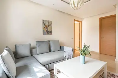 a living room with a couch and a table at Lovely Appartement Prestigia Hayriad in Rabat