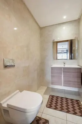a bathroom with a toilet and a sink at Lovely Appartement Prestigia Hayriad in Rabat