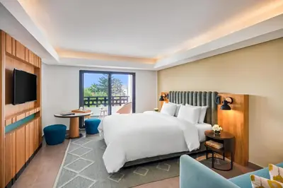 a hotel room with a bed and a tv at Pullman Mazagan Royal Golf & Spa in El Jadida