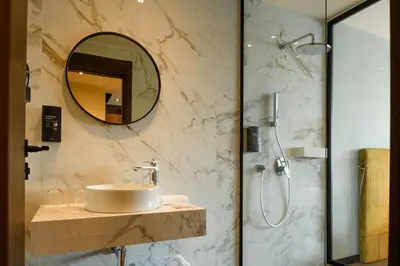 a bathroom with a sink and a shower with a mirror at JM Suites Hotel Eco-Friendly Casablanca in Casablanca