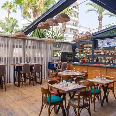 a restaurant with tables and chairs and a bar at JM Suites Hotel Eco-Friendly Casablanca in Casablanca
