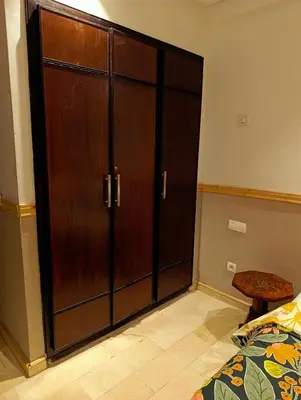 a large wooden door in a bedroom with a bed at Appartement de Charme Avec Vue Sur Mer in Casablanca