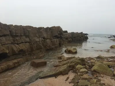 a beach with rocks and the water and the ocean at Appartement de Charme Avec Vue Sur Mer in Casablanca