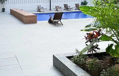 a patio with two chairs and a swimming pool at luxe appartement met zeezicht en zwembad Mohammedia Parc in Mohammedia