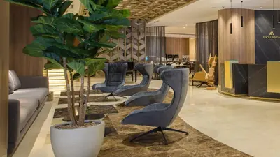 a waiting room with chairs and a potted plant at Idou Anfa Hôtel & Spa in Casablanca