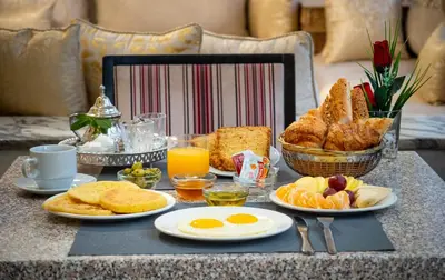 a breakfast table with eggs and bread and toast at Hotel Casablanca City Center in Casablanca