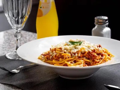 a white plate of food with rice and pasta at Hotel Casablanca City Center in Casablanca