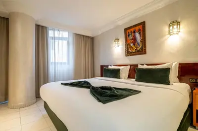 a bedroom with a large white bed in a room at Hotel Casablanca City Center in Casablanca