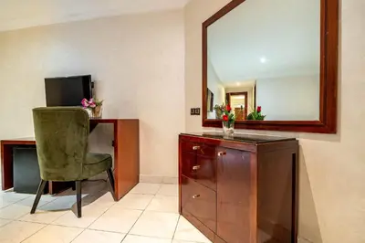 a room with a mirror and a chair and a dresser at Hotel Casablanca City Center in Casablanca
