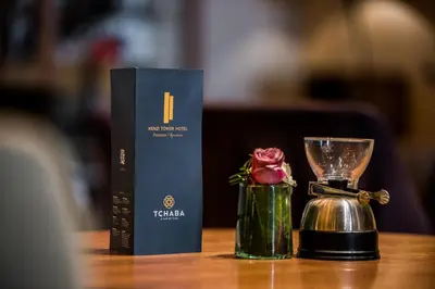 a table with a box and a cup and a flower at Kenzi Tower Hotel in Casablanca