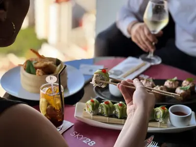 a group of people sitting at a table eating sushi at Kenzi Tower Hotel in Casablanca