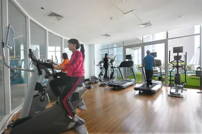 a woman exercising on a treadmill in a gym at Kenzi Tower Hotel in Casablanca