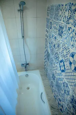 a bath tub in a bathroom with a shower at Instant Saisons - Ferme d'hôtes in Skhirat