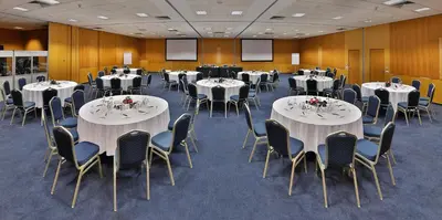 a conference room with tables and chairs and screens at L' Amphitrite Palace Beach Resort & Spa in Skhirat