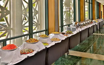 a row of tables filled with different types of food at L' Amphitrite Palace Beach Resort & Spa in Skhirat