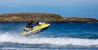 a man riding a jet ski in the water at L' Amphitrite Palace Beach Resort & Spa in Skhirat