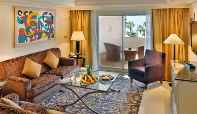 a living room with a couch and a table at L' Amphitrite Palace Beach Resort & Spa in Skhirat