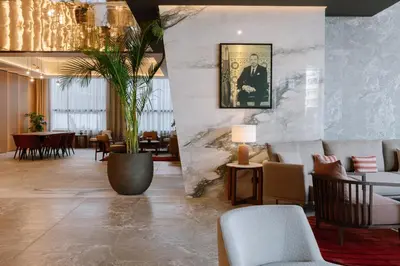 a lobby with chairs and a table with a picture on the wall at Royal Hideaway Casablanca in Casablanca