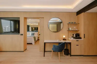 a room with a bed and a table and a mirror at Royal Hideaway Casablanca in Casablanca