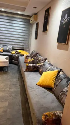 a group of couches sitting in a room at Résidence Galets Sur Mer in Dar Bouazza