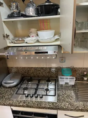 a kitchen counter with a stove top in a kitchen at Résidence Galets Sur Mer in Dar Bouazza