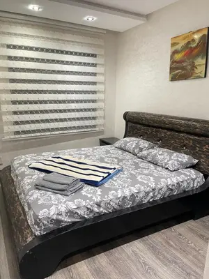 a bedroom with a bed with towels on it at Résidence Galets Sur Mer in Dar Bouazza