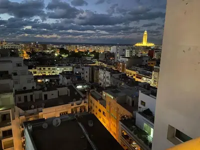 a view of a city at night at Amazing view overlooking the ocean and Hassan 2 in Casablanca