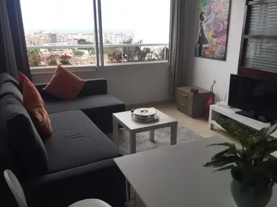 a living room with a couch and a table at Amazing view overlooking the ocean and Hassan 2 in Casablanca