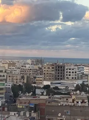 a view of a city with buildings and the ocean at Amazing view overlooking the ocean and Hassan 2 in Casablanca