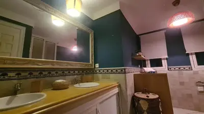 a bathroom with two sinks and a large mirror at Océan Beach in Tamaris