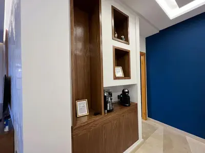 a hallway with a blue wall and a wooden door at offering a fantastic Apartment in Casablanca
