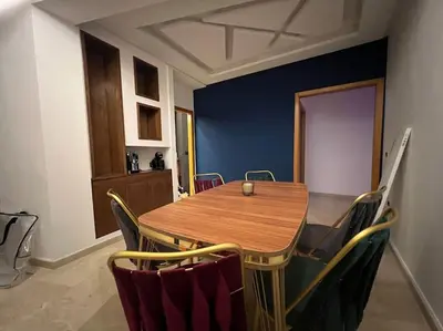 a dining room with a wooden table and chairs at offering a fantastic Apartment in Casablanca
