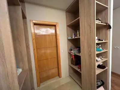a closet with a wooden door in a room at offering a fantastic Apartment in Casablanca