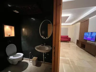 a bathroom with a sink and a toilet and a mirror at offering a fantastic Apartment in Casablanca