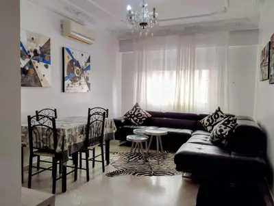 a living room with a couch and a table at Splendid appartament a 3 Min de la mer et de la mosquée hassan 2 in Casablanca