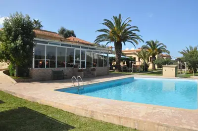a swimming pool in front of a house at Gite Nadia in Casablanca