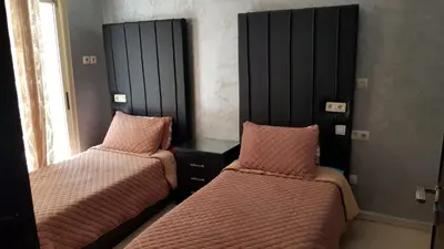 two beds in a room with pink beds at Deluxe apartments in Casablanca