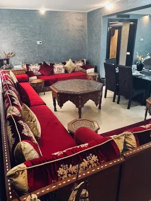 a living room with a red couch and a table at Deluxe apartments in Casablanca