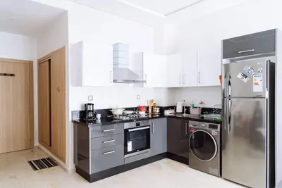 a kitchen with a stainless steel refrigerator and a dishwasher at Cozy New Studio in Mohammedia in Mohammedia