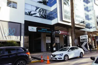 a white car parked in front of a building at Cozy New Studio in Mohammedia in Mohammedia