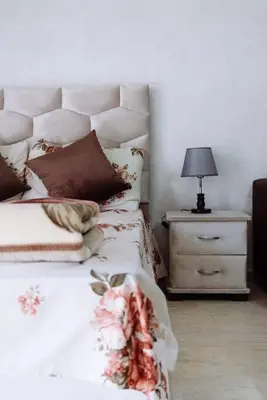 a bedroom with a bed and a night stand with a lamp at Cozy New Studio in Mohammedia in Mohammedia