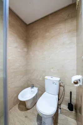 a bathroom with a toilet and a sink at Arribat Center Mall- TT Holidays Agdal in Rabat
