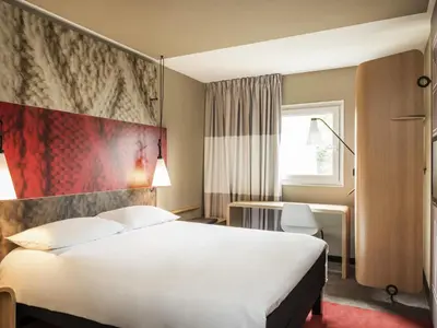 a hotel room with a bed and a desk at Ibis Casablanca Sidi Maarouf in Casablanca