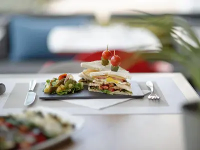 a sandwich on a plate on a table at Ibis Casablanca Sidi Maarouf in Casablanca