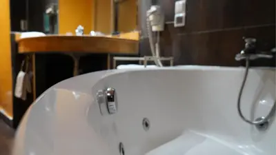 a white bath tub in a bathroom with a sink at Hotel Toubkal in Casablanca
