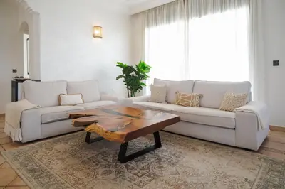 a living room with a couch and a coffee table at Sunset escape by the sea in Temara