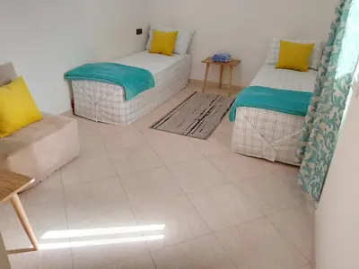 a living room with two beds and a couch at Dar Ziyad Airport in Casablanca