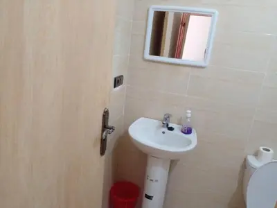 a bathroom with a sink and a mirror and a toilet at Dar Ziyad Airport in Casablanca
