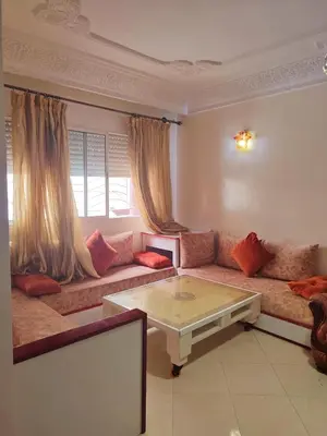 a living room with a couch and a coffee table at Appartement propre et bien équipé à Ain sebaa in Casablanca
